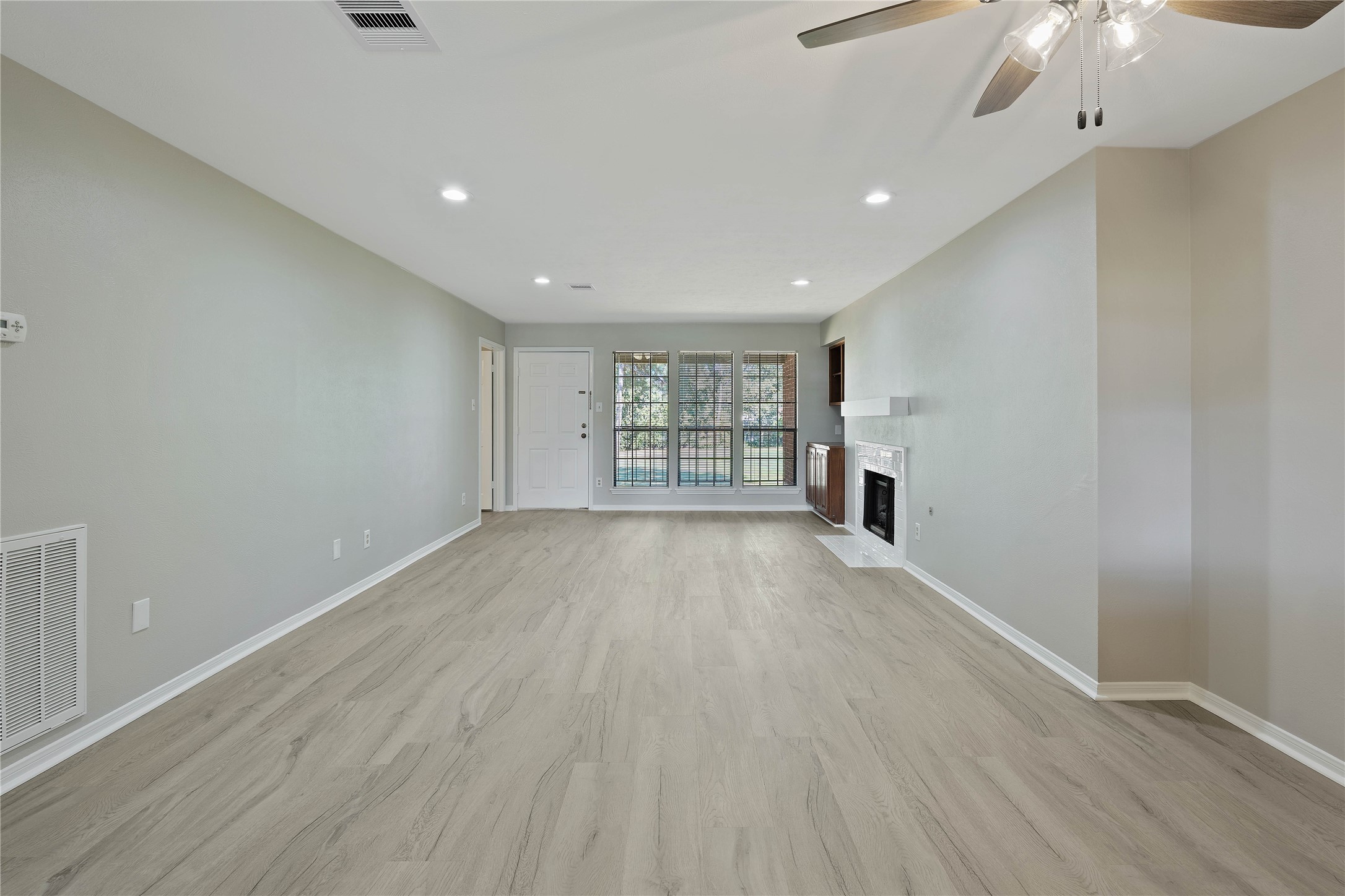 200 Panorama Drive, Unit 107 Conroe, TX 77304 - Photo 5 of 32 wooden floor in an empty room with a window