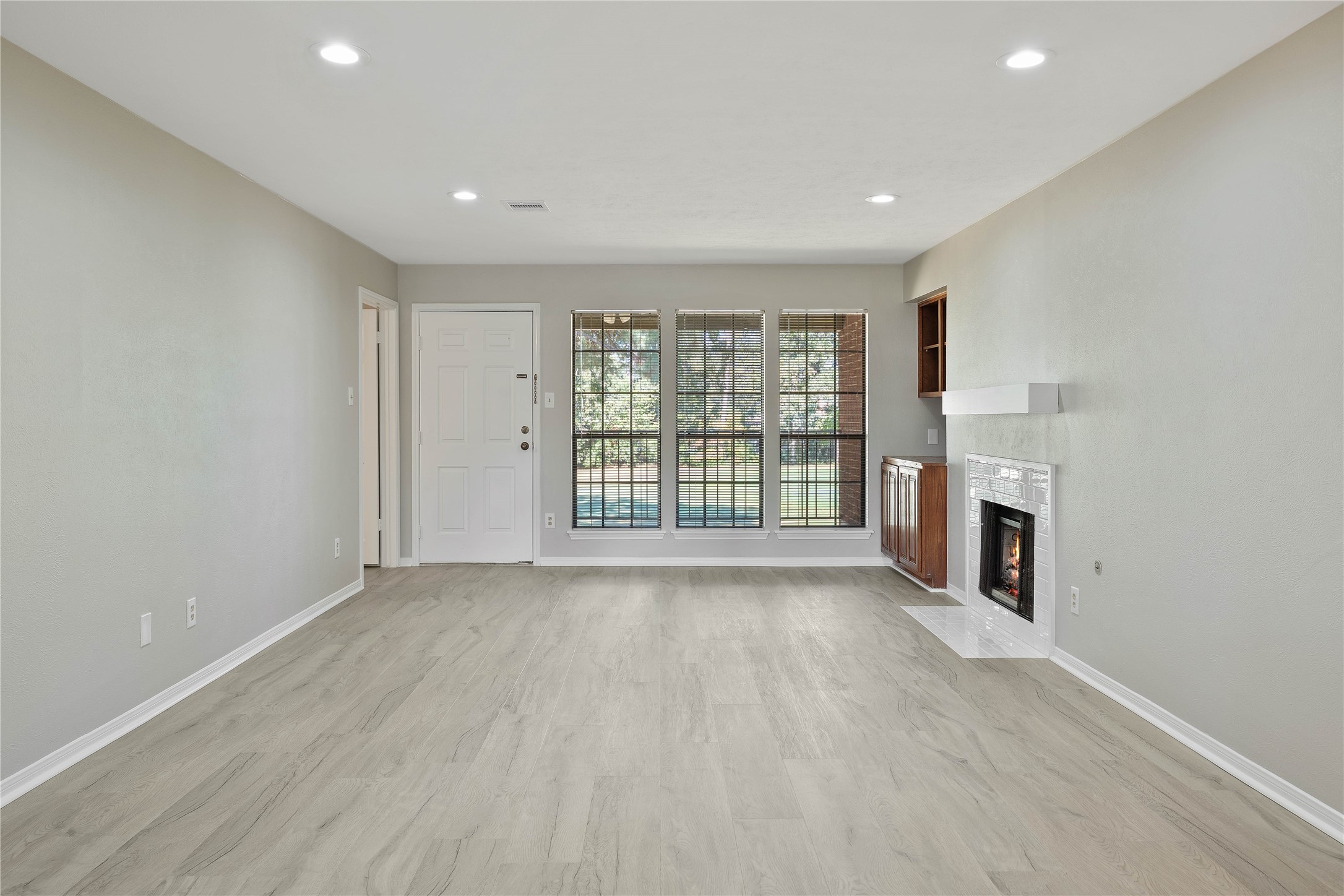 200 Panorama Drive, Unit 107 Conroe, TX 77304 - Photo 6 of 32 a view of an empty room with a fireplace and a window