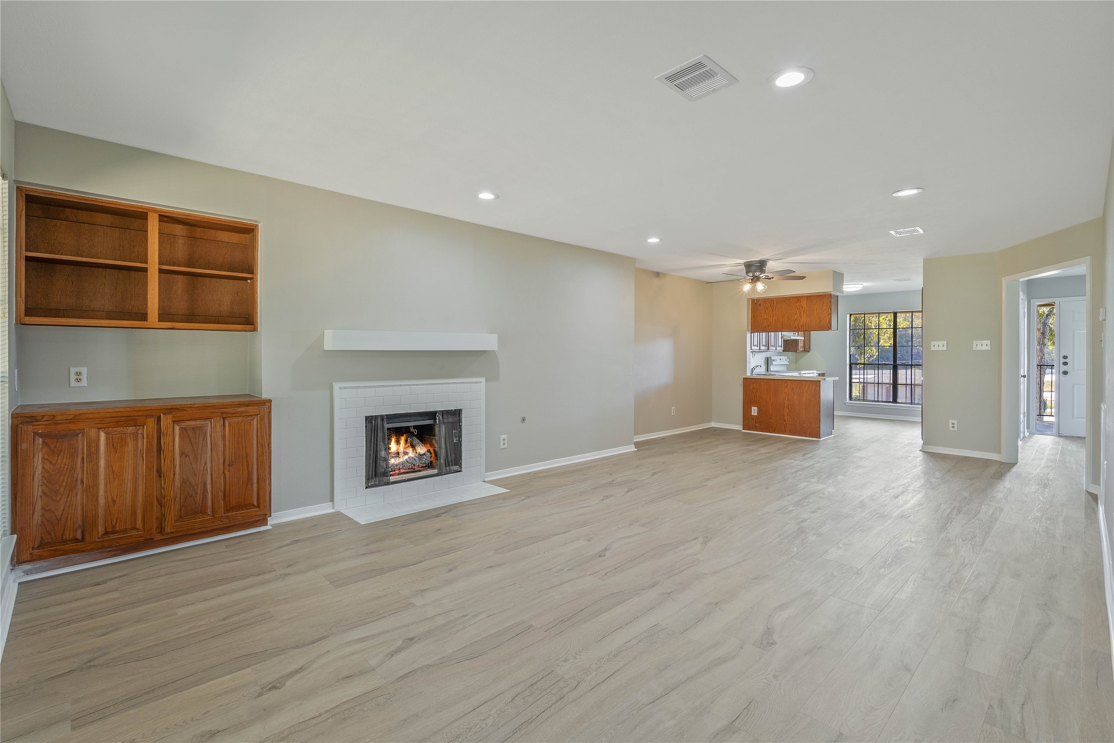 200 Panorama Drive, Unit 107 Conroe, TX 77304 - Photo 8 of 32 a view of an empty room with a fireplace and window