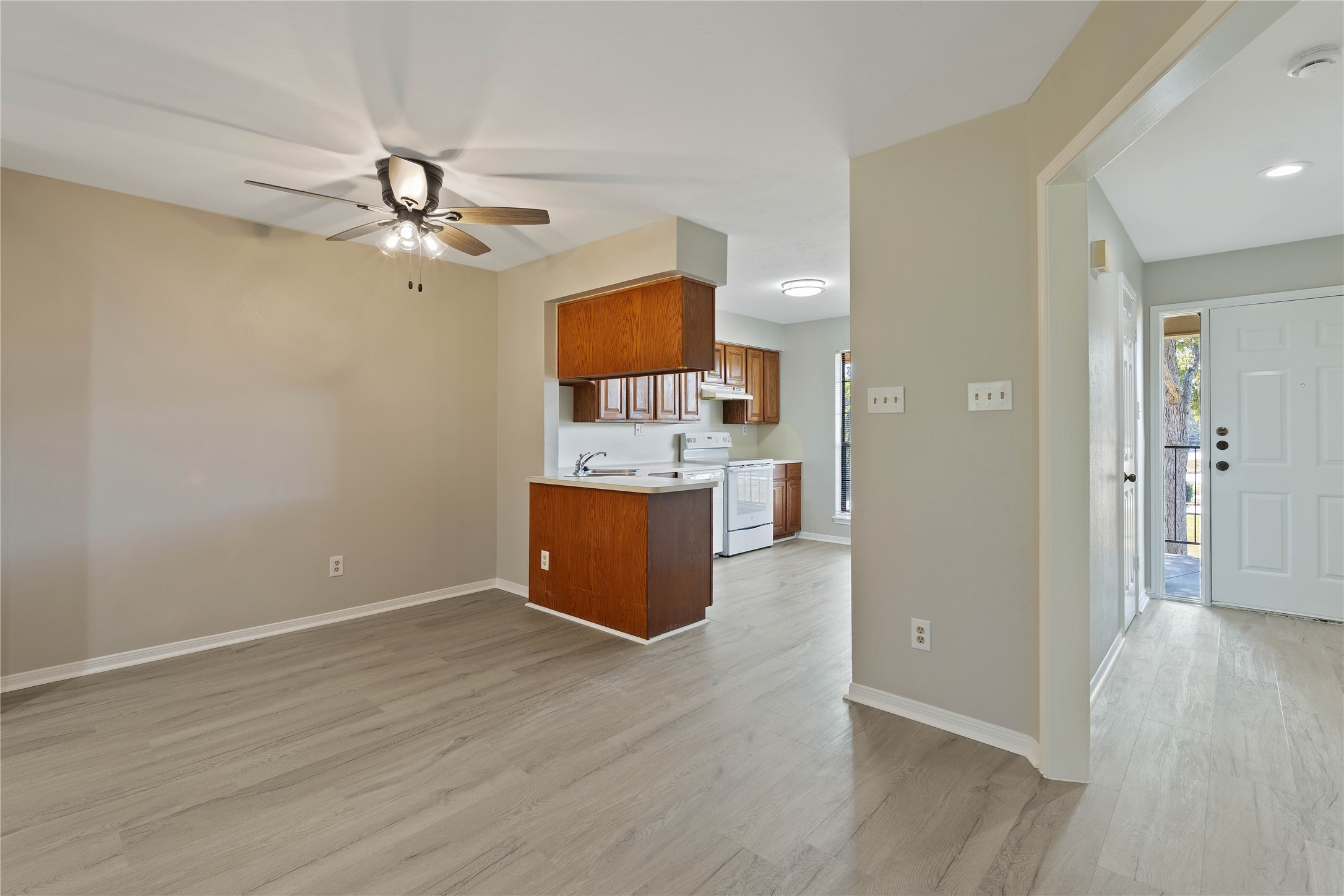 200 Panorama Drive, Unit 107 Conroe, TX 77304 - Photo 9 of 32 a view of a kitchen with a sink and a cabinet wooden floor