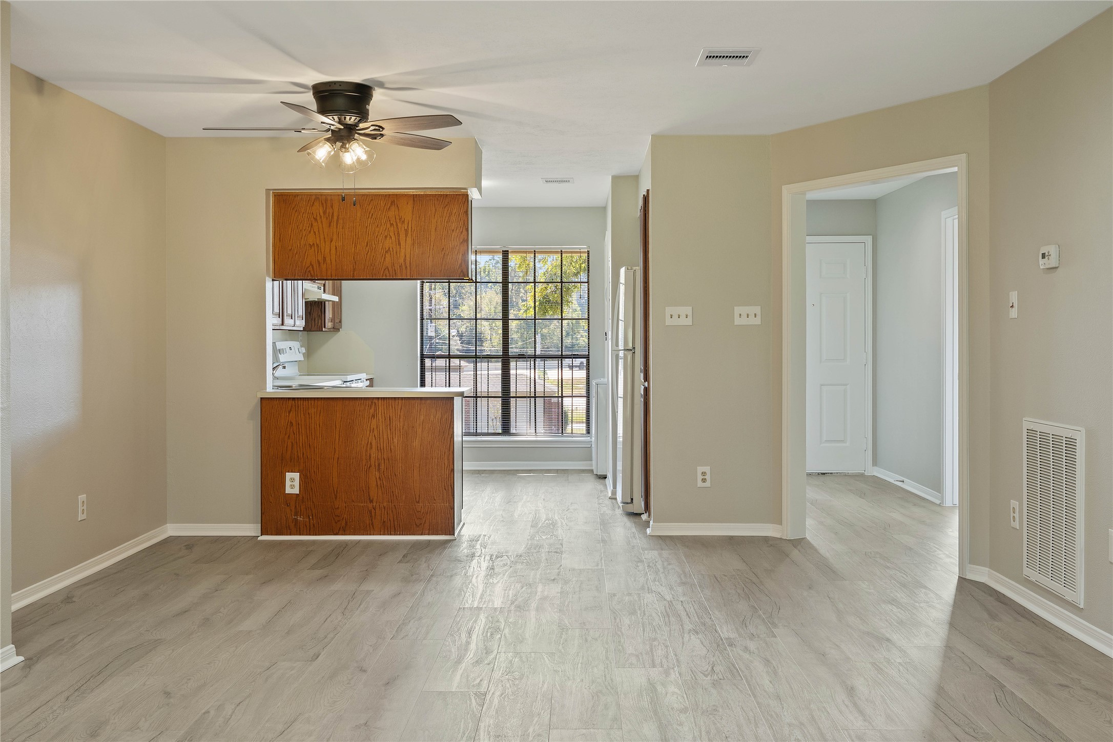 200 Panorama Drive, Unit 107 Conroe, TX 77304 - Photo 10 of 32 a view of a room with a chandelier and wooden floor