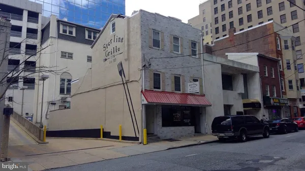 a front view of a building with parking space