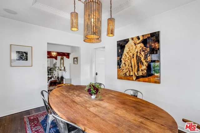 a bedroom with a bed and painting on the wall