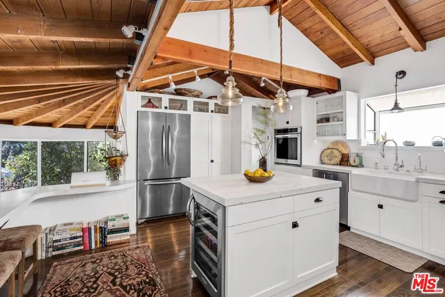 a kitchen with a sink a stove and cabinets