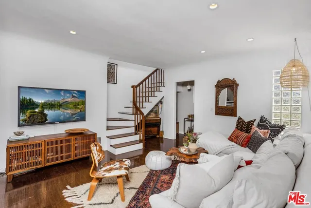 a living room with furniture window and wooden floor