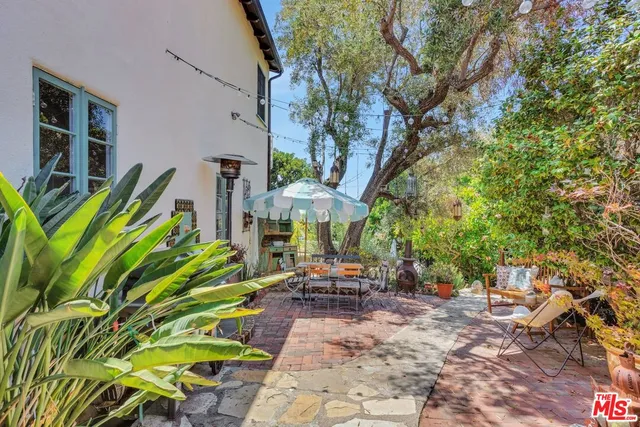 a backyard of a house with table and chairs