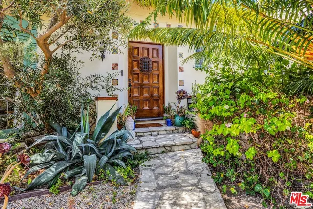 a sign board with tall trees