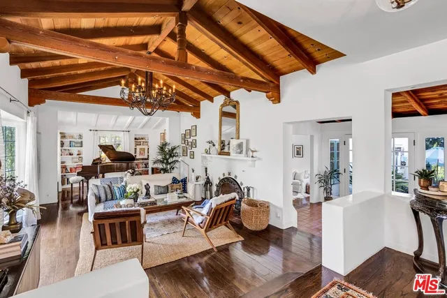 a living room with lots of furniture and clutter
