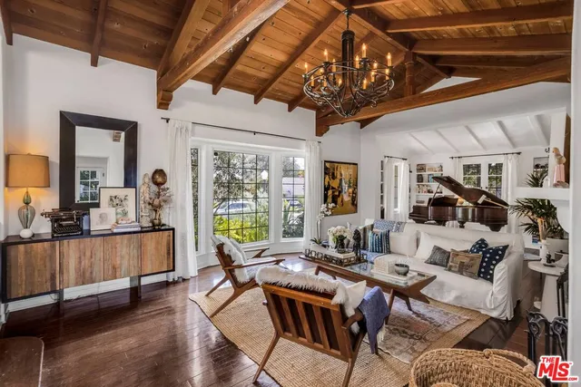 a living room with lots of furniture and a chandelier