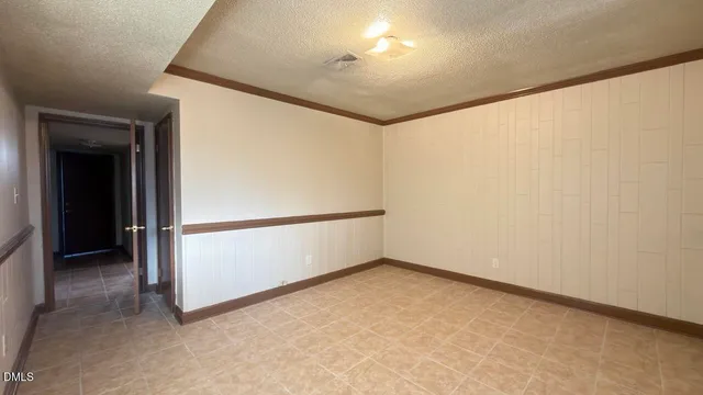 an empty room with sliding door and wooden floor