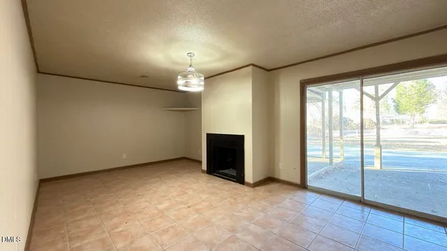 a view of an empty room with a fireplace