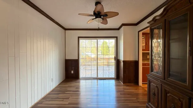 a view of hallway with wooden floor and chandelier