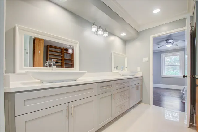a spacious bathroom with a shower a sink and a large mirror