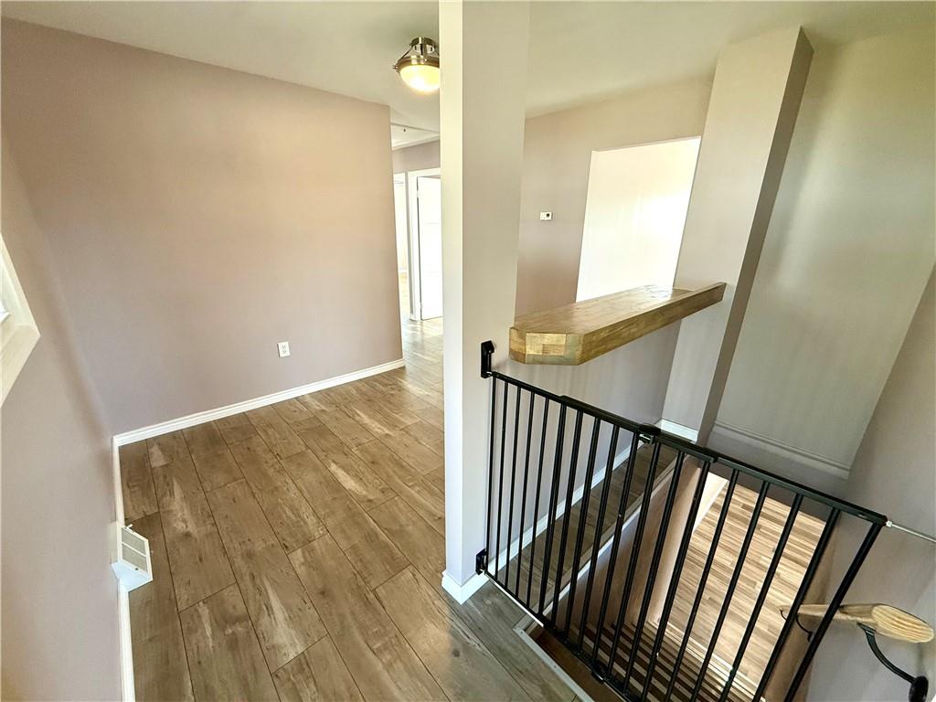2118 Brodhead Road Aliquippa, PA 15001 - Photo 12 of 35 a view of a hallway with wooden floor and staircase