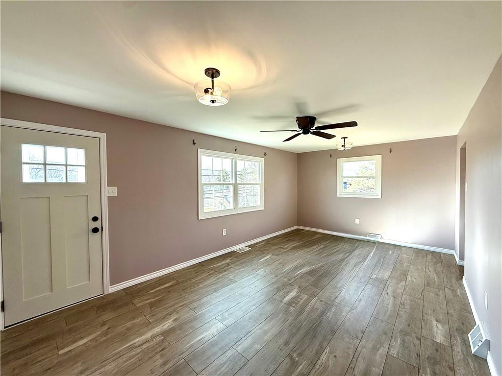 2118 Brodhead Road Aliquippa, PA 15001 - Photo 13 of 35 an empty room with wooden floor chandelier and windows