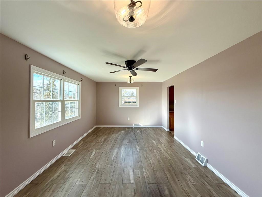 2118 Brodhead Road Aliquippa, PA 15001 - Photo 14 of 35 an empty room with wooden floor chandelier fan and windows