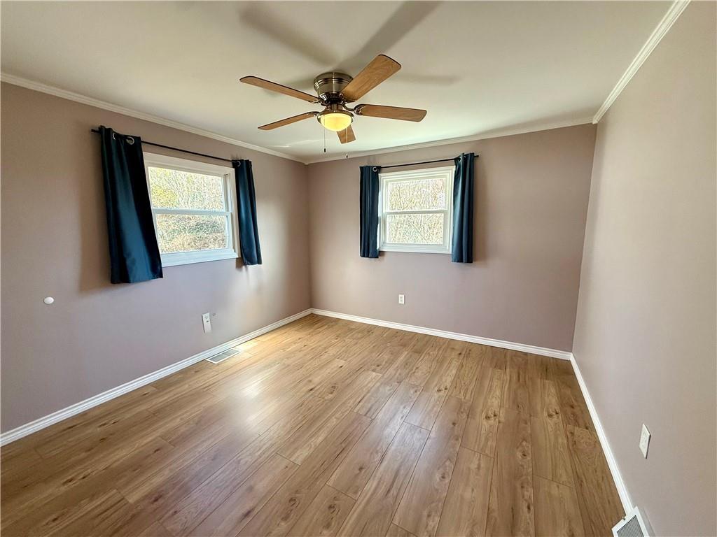2118 Brodhead Road Aliquippa, PA 15001 - Photo 19 of 35 an empty room with wooden floor fan and windows