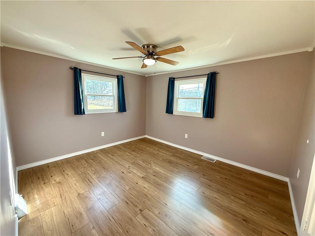 2118 Brodhead Road Aliquippa, PA 15001 - Photo 21 of 35 a view of an empty room with window and wooden floor