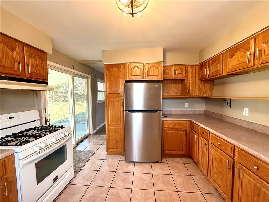 2118 Brodhead Road Aliquippa, PA 15001 - Photo 6 of 35 a kitchen with stainless steel appliances granite countertop a stove a sink and a refrigerator