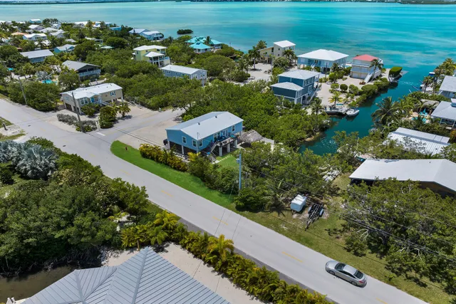 an aerial view of a house with a garden and lake view