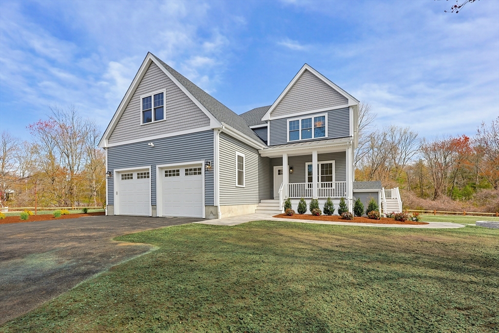 889 Maple Street Mansfield, MA 02048 - Photo 1 of 42 a front view of a house with a yard