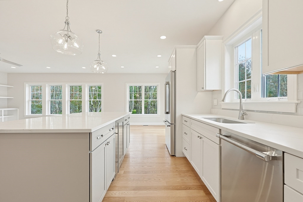 889 Maple Street Mansfield, MA 02048 - Photo 12 of 42 a large white kitchen with a large window