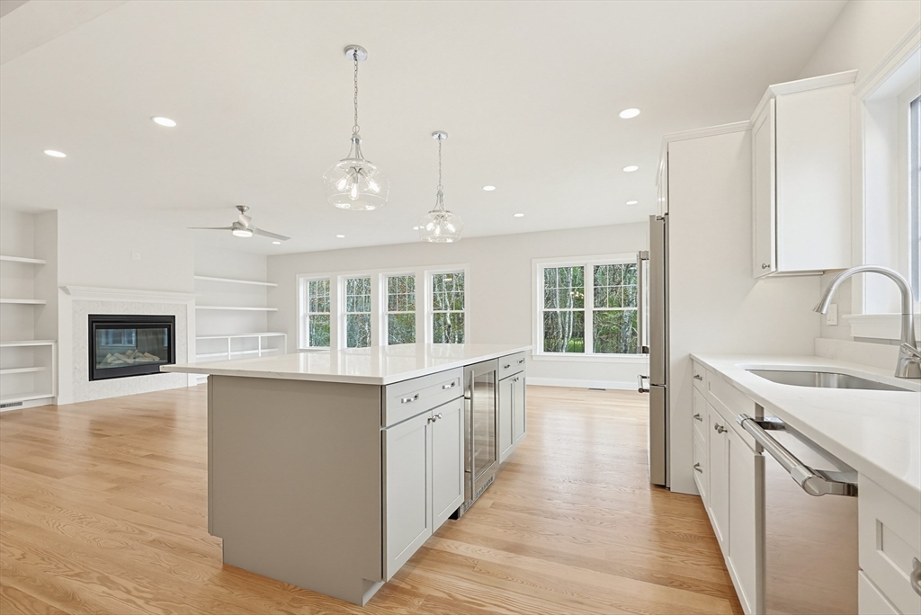 889 Maple Street Mansfield, MA 02048 - Photo 13 of 42 a large kitchen with stainless steel appliances granite countertop a sink and dishwasher with a large window