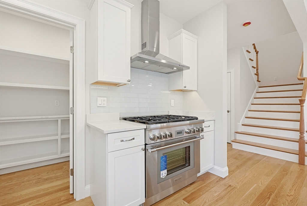 889 Maple Street Mansfield, MA 02048 - Photo 14 of 42 a kitchen with stainless steel appliances a stove and a refrigerator