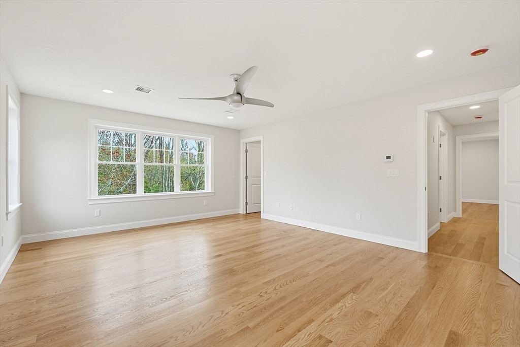 889 Maple Street Mansfield, MA 02048 - Photo 24 of 42 a view of an empty room with wooden floor and a window