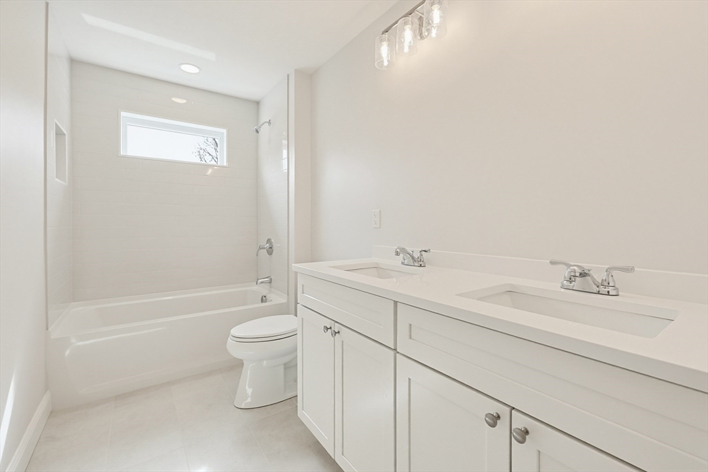 889 Maple Street Mansfield, MA 02048 - Photo 32 of 42 a bathroom with a double vanity sink toilet and shower