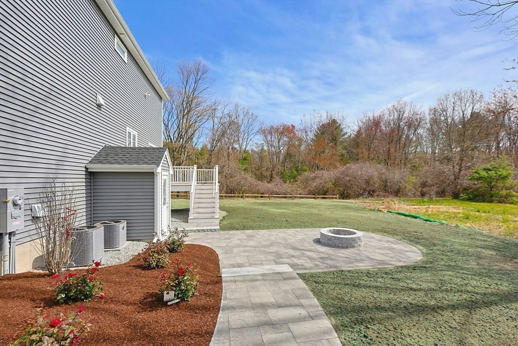 889 Maple Street Mansfield, MA 02048 - Photo 40 of 42 a view of a house with backyard and a garden