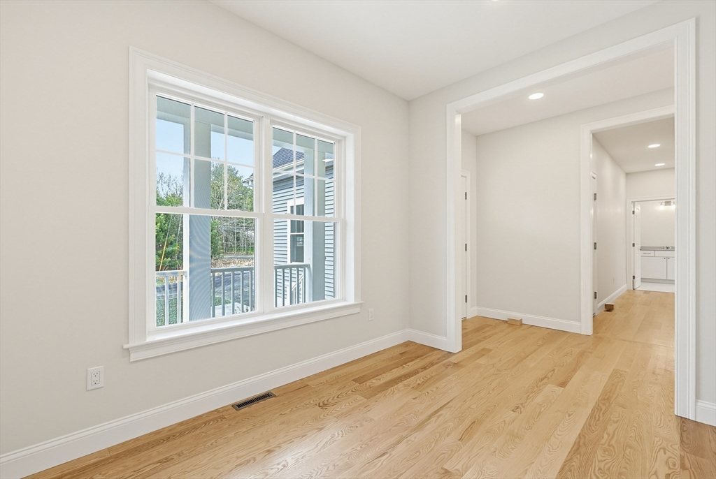889 Maple Street Mansfield, MA 02048 - Photo 4 of 42 an empty room with wooden floor and windows