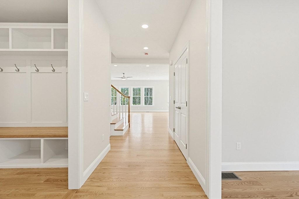889 Maple Street Mansfield, MA 02048 - Photo 5 of 42 a view of a hallway with wooden floor and staircase