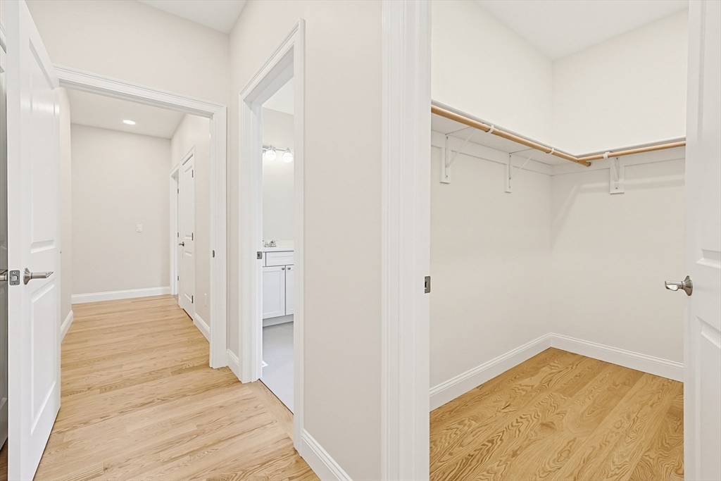 889 Maple Street Mansfield, MA 02048 - Photo 8 of 42 a view of a hallway with wooden floor and a bathroom