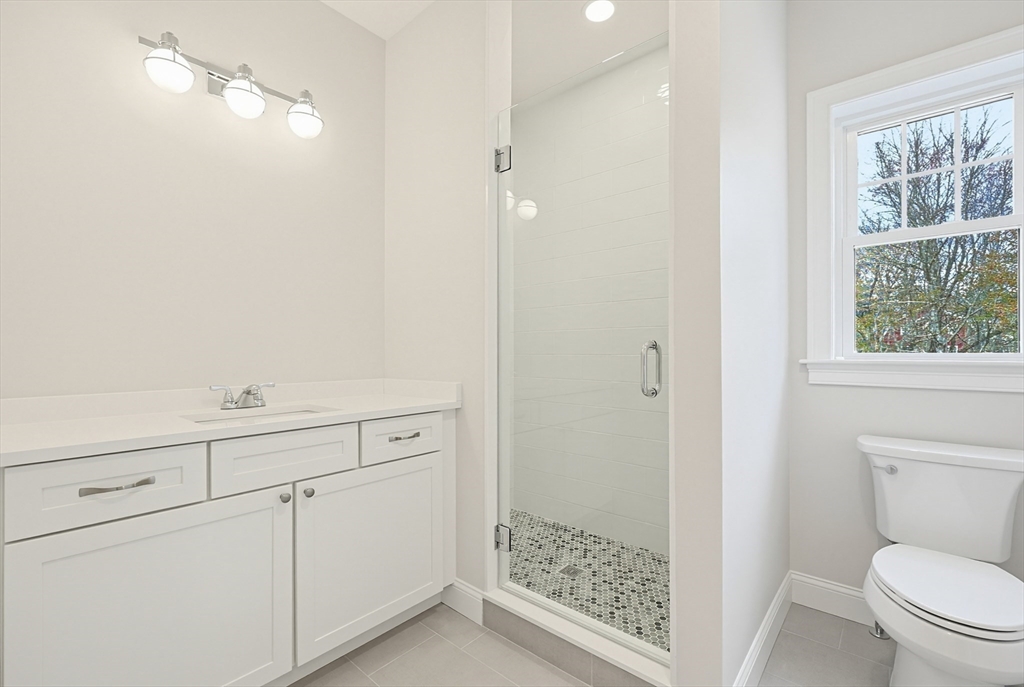 889 Maple Street Mansfield, MA 02048 - Photo 10 of 42 a bathroom with a shower toilet and sink