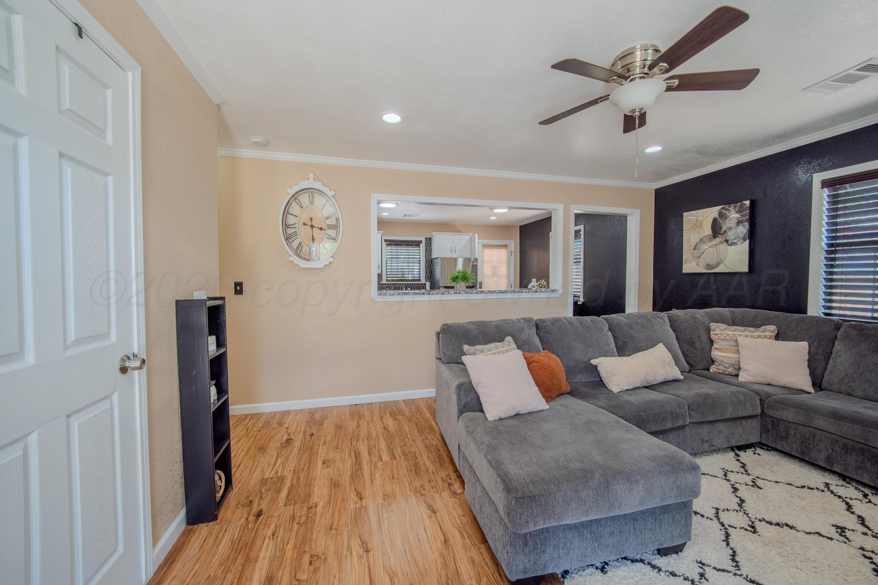 4014 Gables Street Amarillo, TX 79110 - Photo 2 of 14 a living room with furniture and a wooden floor