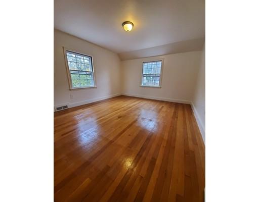 1570 Plumtree Road Springfield, MA 01119 - Photo 11 of 19 a view of an empty room with a window and wooden floor