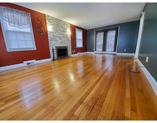 1570 Plumtree Road Springfield, MA 01119 - Photo 3 of 19 a view of an empty room with wooden floor and a fireplace