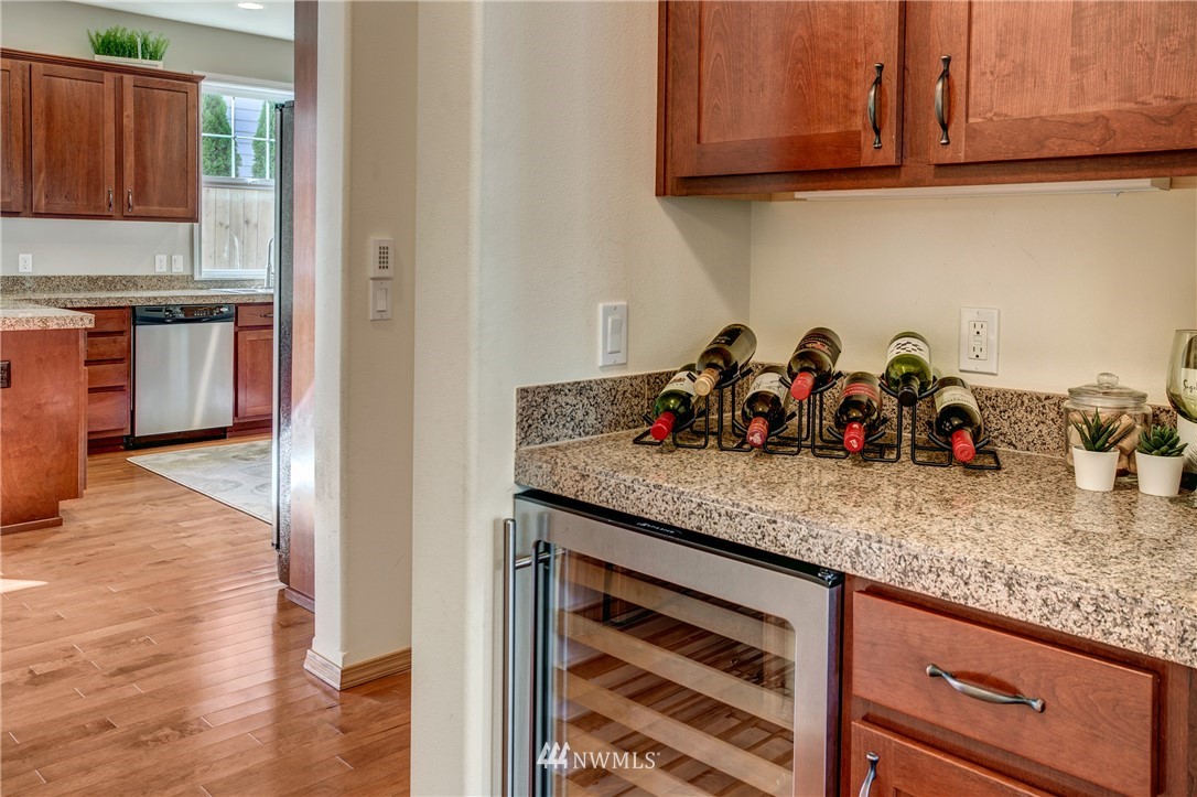 6709 Southeast 2nd Place Renton, WA 98059 - Photo 15 of 25 a kitchen with granite countertop cabinets and wooden floor