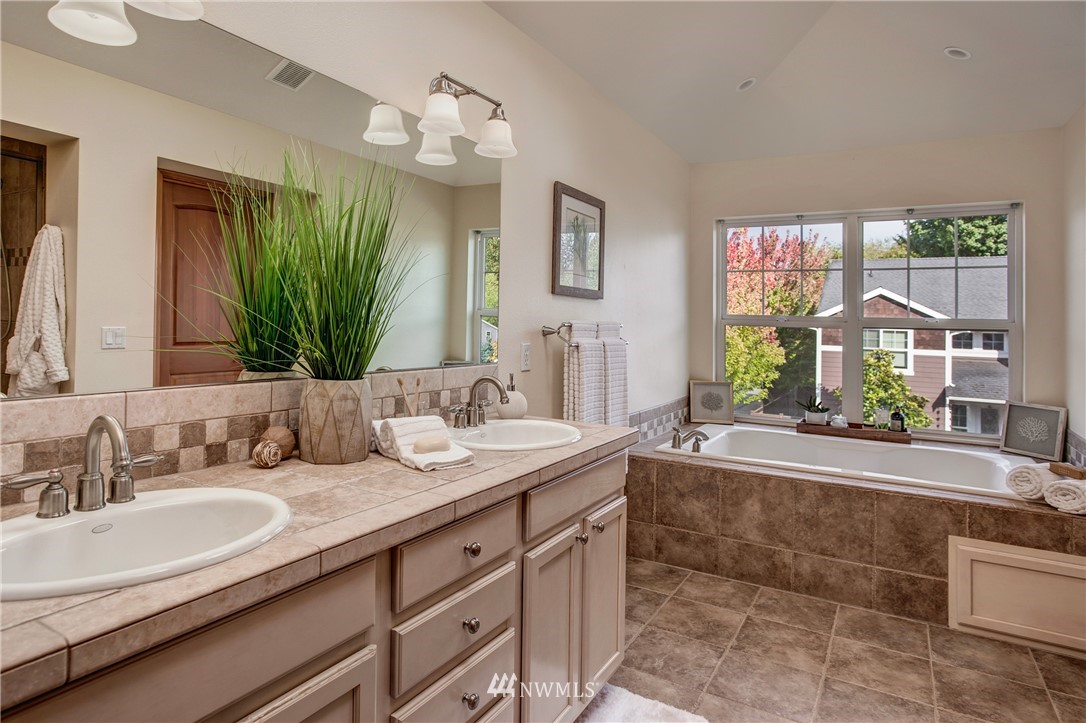 6709 Southeast 2nd Place Renton, WA 98059 - Photo 18 of 25 a bathroom with a granite countertop tub sink and mirror