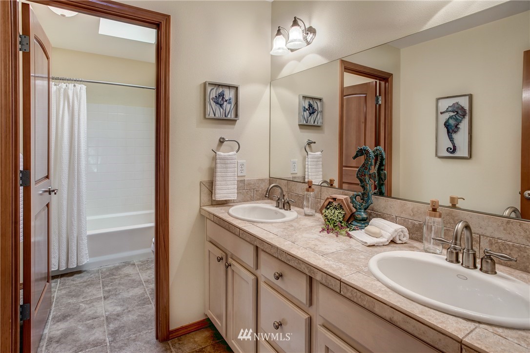 6709 Southeast 2nd Place Renton, WA 98059 - Photo 20 of 25 a bathroom with a double vanity sink and a mirror