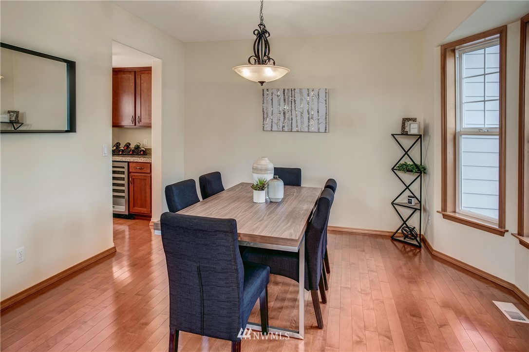 6709 Southeast 2nd Place Renton, WA 98059 - Photo 6 of 25 a view of a dining room with furniture window and wooden floor