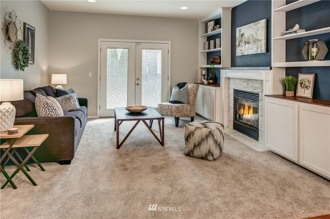 6709 Southeast 2nd Place Renton, WA 98059 - Photo 8 of 25 a living room with furniture and a fireplace