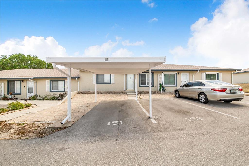 a view of a car park in front of a house