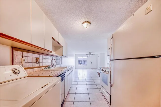 a kitchen with stainless steel appliances a refrigerator sink and cabinets