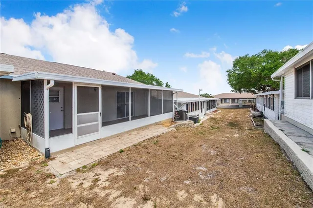 a view of a house with backyard porch and sitting area