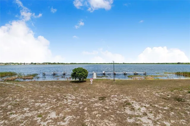 a view of a lake with houses in the back