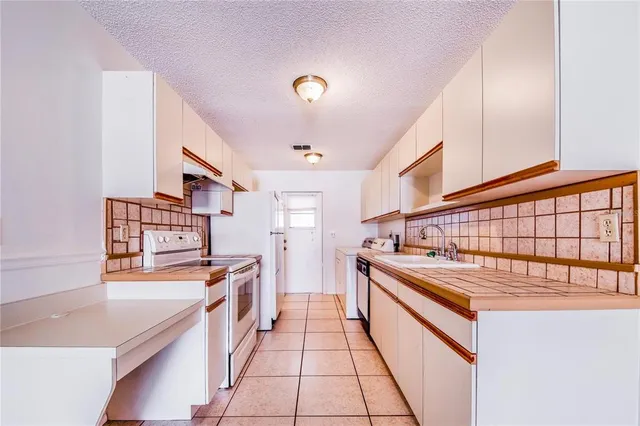 a kitchen with stainless steel appliances granite countertop a sink and cabinets