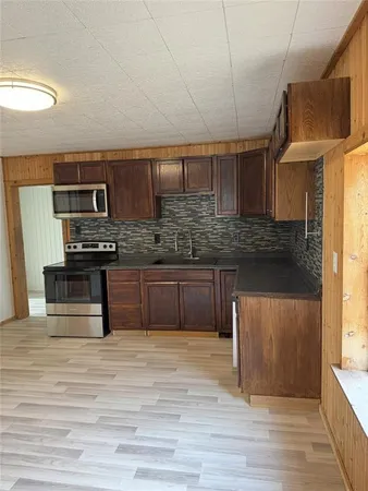 a view of kitchen with sink and microwave
