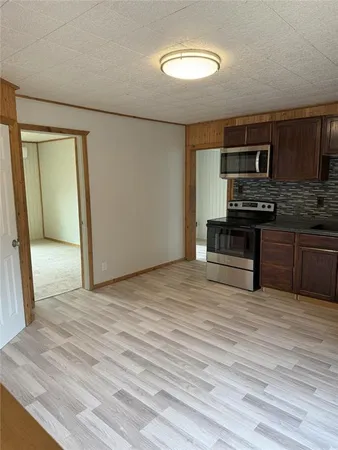a kitchen with stainless steel appliances kitchen island granite countertop a stove a sink and a microwave